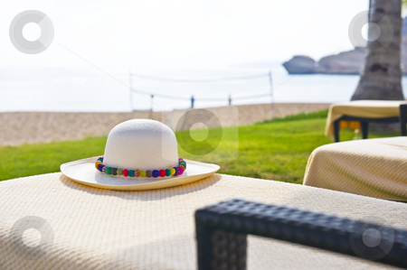 To use this stock image in your creative project, please select the size you need over to the right and click the "Add to Cart" button.
Your downloaded image will come with the Cutcaster watermark removed so don’t worry about the watermark you see on this page. A Panama hat with colorful brim stock photo, A Panama hat on a chair next to the beach with colorful decoration. by Nicolaas Traut