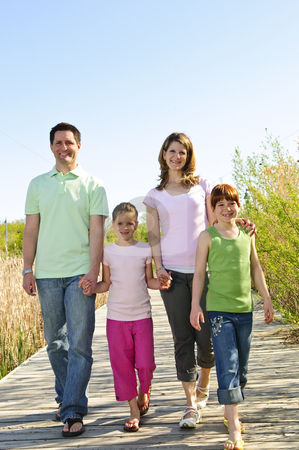 To use this stock image in your creative project, please select the size you need over to the right and click the "Add to Cart" button.
Your downloaded image will come with the Cutcaster watermark removed so don’t worry about the watermark you see on this page. Happy family stock photo, Portrait of happy family of four walking on boardwalk by Elena Elisseeva