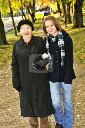 To use this stock image in your creative project, please select the size you need over to the right and click the "Add to Cart" button.
Your downloaded image will come with the Cutcaster watermark removed so don’t worry about the watermark you see on this page. Granddaughter walking with grandmother stock photo, Teen granddaughter walking with grandmother in autumn park by Elena Elisseeva