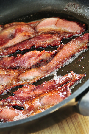 To use this stock image in your creative project, please select the size you need over to the right and click the "Add to Cart" button.
Your downloaded image will come with the Cutcaster watermark removed so don’t worry about the watermark you see on this page. Bacon frying in a pan stock photo, Bacon strips sizzling on a frying pan by Elena Elisseeva