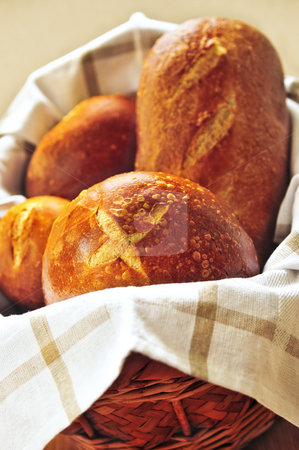 To use this stock image in your creative project, please select the size you need over to the right and click the "Add to Cart" button.
Your downloaded image will come with the Cutcaster watermark removed so don’t worry about the watermark you see on this page. Bread in basket stock photo, Small and large round loaves of sourdough bread in basket by Elena Elisseeva