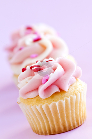 To use this stock image in your creative project, please select the size you need over to the right and click the "Add to Cart" button.
Your downloaded image will come with the Cutcaster watermark removed so don’t worry about the watermark you see on this page. Cupcakes stock photo, Row of tasty cupcakes with icing and sprinkles by Elena Elisseeva