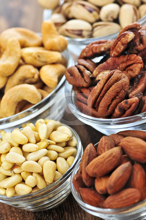 To use this stock image in your creative project, please select the size you need over to the right and click the "Add to Cart" button.
Your downloaded image will come with the Cutcaster watermark removed so don’t worry about the watermark you see on this page. Bowls of nuts stock photo, Almonds, cashews pistachio and pine nuts in glass bowls by Elena Elisseeva