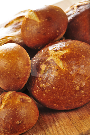 To use this stock image in your creative project, please select the size you need over to the right and click the "Add to Cart" button.
Your downloaded image will come with the Cutcaster watermark removed so don’t worry about the watermark you see on this page. Loaves of bread stock photo, Small and large round loaves of sourdough bread by Elena Elisseeva