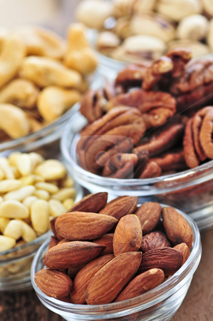 To use this stock image in your creative project, please select the size you need over to the right and click the "Add to Cart" button.
Your downloaded image will come with the Cutcaster watermark removed so don’t worry about the watermark you see on this page. Bowls of nuts stock photo, Almonds, cashews pistachio and pine nuts in glass bowls by Elena Elisseeva