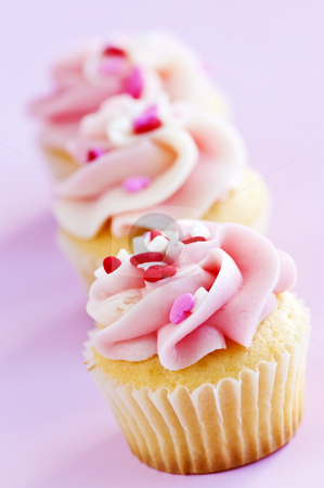 To use this stock image in your creative project, please select the size you need over to the right and click the "Add to Cart" button.
Your downloaded image will come with the Cutcaster watermark removed so don’t worry about the watermark you see on this page. Cupcakes stock photo, Row of tasty cupcakes with icing and sprinkles by Elena Elisseeva