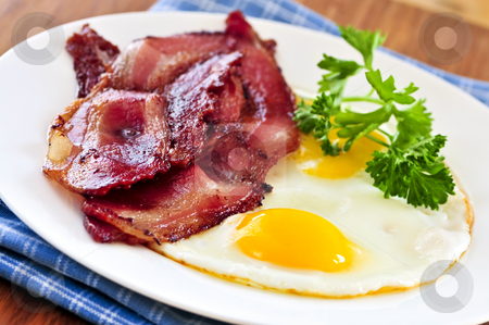 To use this stock image in your creative project, please select the size you need over to the right and click the "Add to Cart" button.
Your downloaded image will come with the Cutcaster watermark removed so don’t worry about the watermark you see on this page. Bacon and eggs stock photo, Tasty breakfast of bacon and fried eggs by Elena Elisseeva
