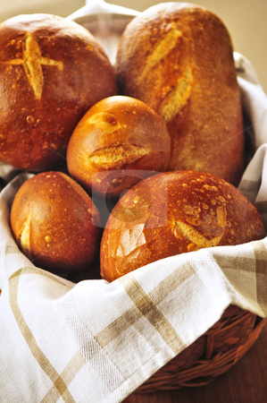 To use this stock image in your creative project, please select the size you need over to the right and click the "Add to Cart" button.
Your downloaded image will come with the Cutcaster watermark removed so don’t worry about the watermark you see on this page. Bread in basket stock photo, Small and large round loaves of sourdough bread in basket by Elena Elisseeva
