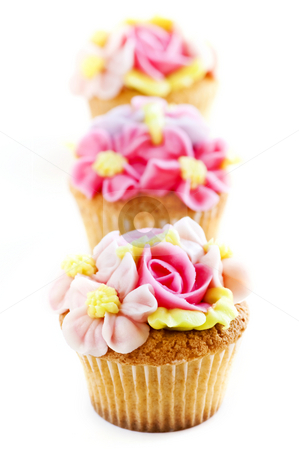 To use this stock image in your creative project, please select the size you need over to the right and click the "Add to Cart" button.
Your downloaded image will come with the Cutcaster watermark removed so don’t worry about the watermark you see on this page. Cupcakes stock photo, Row of tasty cupcakes with icing flowers by Elena Elisseeva