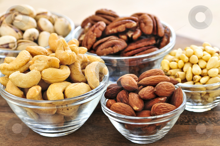 To use this stock image in your creative project, please select the size you need over to the right and click the "Add to Cart" button.
Your downloaded image will come with the Cutcaster watermark removed so don’t worry about the watermark you see on this page. Bowls of nuts stock photo, Almonds, cashews pistachio and pine nuts in glass bowls by Elena Elisseeva