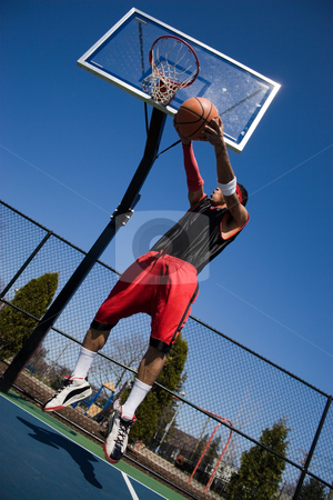 To use this stock image in your creative project, please select the size you need over to the right and click the "Add to Cart" button.
Your downloaded image will come with the Cutcaster watermark removed so don’t worry about the watermark you see on this page. Man Playing Basketball stock photo, A young basketball player driving to the hoop with some fancy moves. by Todd Arena