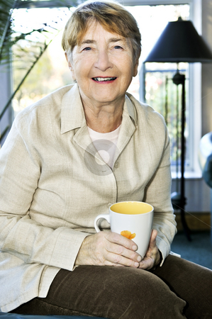 To use this stock image in your creative project, please select the size you need over to the right and click the "Add to Cart" button.
Your downloaded image will come with the Cutcaster watermark removed so don’t worry about the watermark you see on this page. Elderly woman relaxing stock photo, Senior woman sitting and smiling happily with cup of tea by Elena Elisseeva