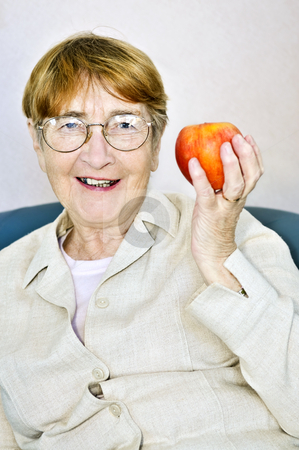 To use this stock image in your creative project, please select the size you need over to the right and click the "Add to Cart" button.
Your downloaded image will come with the Cutcaster watermark removed so don’t worry about the watermark you see on this page. Elderly woman with apple stock photo, Elderly woman eating healthy holding a nutritious apple by Elena Elisseeva
