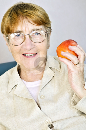 To use this stock image in your creative project, please select the size you need over to the right and click the "Add to Cart" button.
Your downloaded image will come with the Cutcaster watermark removed so don’t worry about the watermark you see on this page. Elderly woman with apple stock photo, Elderly woman eating healthy holding a nutritious apple by Elena Elisseeva