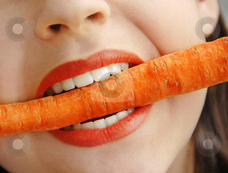To use this stock image in your creative project, please select the size you need over to the right and click the "Add to Cart" button.
Your downloaded image will come with the Cutcaster watermark removed so don’t worry about the watermark you see on this page. Carrot in teeth stock photo, Orange carrot in white girl teeth bite by Julija Sapic