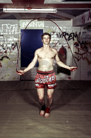 To use this stock image in your creative project, please select the size you need over to the right and click the "Add to Cart" button.
Your downloaded image will come with the Cutcaster watermark removed so don’t worry about the watermark you see on this page. Streetfighter training stock photo, Cross processed image of a muay thai fighter warming up before a practice in a grungy basement by Corepics VOF