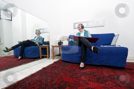 To use this stock image in your creative project, please select the size you need over to the right and click the "Add to Cart" button.
Your downloaded image will come with the Cutcaster watermark removed so don’t worry about the watermark you see on this page. Home office stock photo, Businesswoman going over thick dossiers on a couch in a homely office environment by Corepics VOF