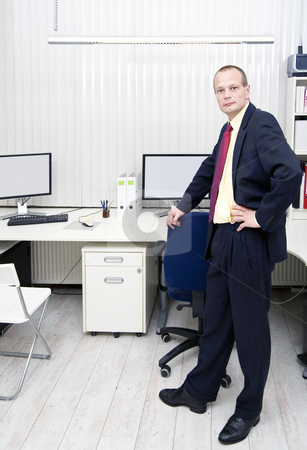 To use this stock image in your creative project, please select the size you need over to the right and click the "Add to Cart" button.
Your downloaded image will come with the Cutcaster watermark removed so don’t worry about the watermark you see on this page. Manager in an office with blinds stock photo, Manager stading in an office in front of a desk with multiple monitors and workstations with vertical blinds by Corepics VOF