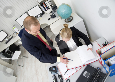 To use this stock image in your creative project, please select the size you need over to the right and click the "Add to Cart" button.
Your downloaded image will come with the Cutcaster watermark removed so don’t worry about the watermark you see on this page. Working together stock photo, Two colleagues working together in a small office by Corepics VOF