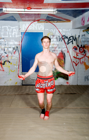 To use this stock image in your creative project, please select the size you need over to the right and click the "Add to Cart" button.
Your downloaded image will come with the Cutcaster watermark removed so don’t worry about the watermark you see on this page. Warming up stock photo, A muaythai fighter skipping rope during a warming up round by Corepics VOF