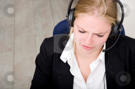 To use this stock image in your creative project, please select the size you need over to the right and click the "Add to Cart" button.
Your downloaded image will come with the Cutcaster watermark removed so don’t worry about the watermark you see on this page. Dedicated receptionist stock photo, A dedicated receptionist at work, using a headset with microphone by Corepics VOF