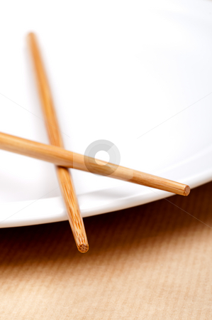 To use this stock image in your creative project, please select the size you need over to the right and click the "Add to Cart" button.
Your downloaded image will come with the Cutcaster watermark removed so don’t worry about the watermark you see on this page. A vertical macro of a pair of chopsticks on a white plate stock photo, A vertical macro of a pair of chopsticks on a white plate by Vince Clements