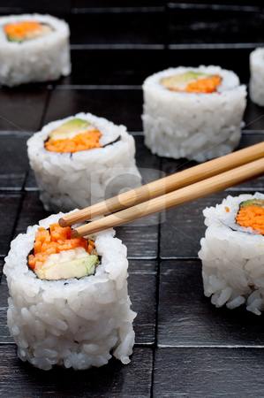 To use this stock image in your creative project, please select the size you need over to the right and click the "Add to Cart" button.
Your downloaded image will come with the Cutcaster watermark removed so don’t worry about the watermark you see on this page. Shallow focus vertical close up of sushi with chopsticks on a bl stock photo, Shallow focus vertical close up of sushi with chopsticks on a black wooden background by Vince Clements