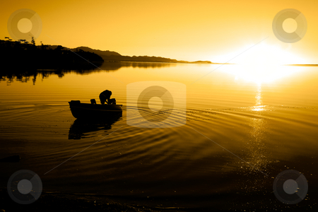 To use this stock image in your creative project, please select the size you need over to the right and click the "Add to Cart" button.
Your downloaded image will come with the Cutcaster watermark removed so don’t worry about the watermark you see on this page. Pacific Northwest Sunset stock photo, A man in a boat at Cline Spit in Sequim Washington. by Travis Manley