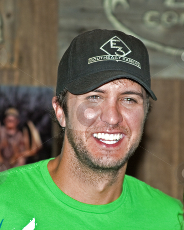 To use this stock image in your creative project, please select the size you need over to the right and click the "Add to Cart" button.
Your downloaded image will come with the Cutcaster watermark removed so don’t worry about the watermark you see on this page. Luke Bryan - CMA Festival 2009 stock photo, Luke Bryan at the CMA Festival 2009 in Nashville, Tennessee signing autographs by Dennis Crumrin