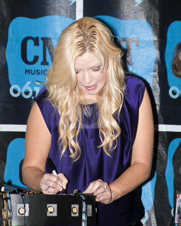 To use this stock image in your creative project, please select the size you need over to the right and click the "Add to Cart" button.
Your downloaded image will come with the Cutcaster watermark removed so don’t worry about the watermark you see on this page. Melissa Peterman - CMA Festival 2009 stock photo, Melissa Peterman at the CMA Festival 2009 in Nashville, Tennessee signing autographs by Dennis Crumrin