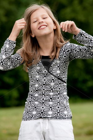 To use this stock image in your creative project, please select the size you need over to the right and click the "Add to Cart" button.
Your downloaded image will come with the Cutcaster watermark removed so don’t worry about the watermark you see on this page. Like my mother in the mirror stock photo, Young talented girl is posing like a little model by Frenk and Danielle Kaufmann
