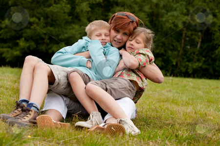 To use this stock image in your creative project, please select the size you need over to the right and click the "Add to Cart" button.
Your downloaded image will come with the Cutcaster watermark removed so don’t worry about the watermark you see on this page. Mother and her 2 kids stock photo, Mother and her kids are happy in the park by Frenk and Danielle Kaufmann