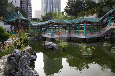 To use this stock image in your creative project, please select the size you need over to the right and click the "Add to Cart" button.
Your downloaded image will come with the Cutcaster watermark removed so don’t worry about the watermark you see on this page. Chinese Water Garden Wong Tai Sin Taoist Temple Kowloon Hong Kon stock photo, Chinese Good Fortune Water Garden Modern Buildings Wong Tai Sin Taoist Temple Kowloon Hong Kong Surrounded by Modern Apartment Buildings by William Perry