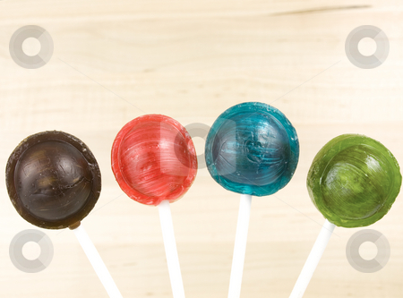 To use this stock image in your creative project, please select the size you need over to the right and click the "Add to Cart" button.
Your downloaded image will come with the Cutcaster watermark removed so don’t worry about the watermark you see on this page. Lollipop Candy stock photo, Four different colored lollipops by John Teeter