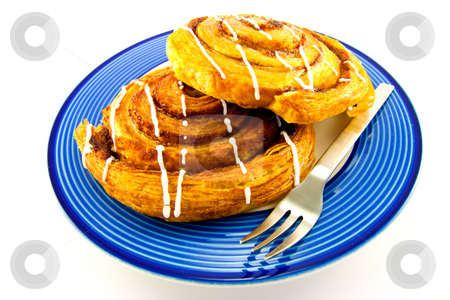 To use this stock image in your creative project, please select the size you need over to the right and click the "Add to Cart" button.
Your downloaded image will come with the Cutcaster watermark removed so don’t worry about the watermark you see on this page. Cinnamon Buns on a Blue Plate stock photo, Two cinnamon buns on a blue plate with fork with clipping path on a white background by Keith Wilson