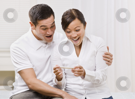 To use this stock image in your creative project, please select the size you need over to the right and click the "Add to Cart" button.
Your downloaded image will come with the Cutcaster watermark removed so don’t worry about the watermark you see on this page. Ecstatic Couple Looking at a Pregnancy Test Together. stock photo, Attractive couple surprised and overjoyed reading pregnancy test. Square composition by Jonathan Ross