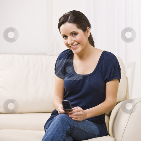 To use this stock image in your creative project, please select the size you need over to the right and click the "Add to Cart" button.
Your downloaded image will come with the Cutcaster watermark removed so don’t worry about the watermark you see on this page. Attractive woman Text Messaging stock photo, Attractive woman sitting on couch and text messaging from her cell phone. Square composition. by Jonathan Ross
