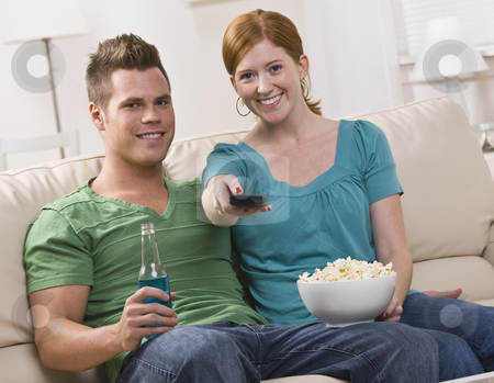 To use this stock image in your creative project, please select the size you need over to the right and click the "Add to Cart" button.
Your downloaded image will come with the Cutcaster watermark removed so don’t worry about the watermark you see on this page. Attractive couple watching TV stock photo, Attractive couple watching TV eating popcorn. horizontal by Jonathan Ross