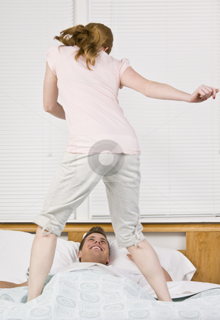 To use this stock image in your creative project, please select the size you need over to the right and click the "Add to Cart" button.
Your downloaded image will come with the Cutcaster watermark removed so don’t worry about the watermark you see on this page. Woman dancing on bed stock photo, Woman dancing on bed over man. Vertical by Jonathan Ross