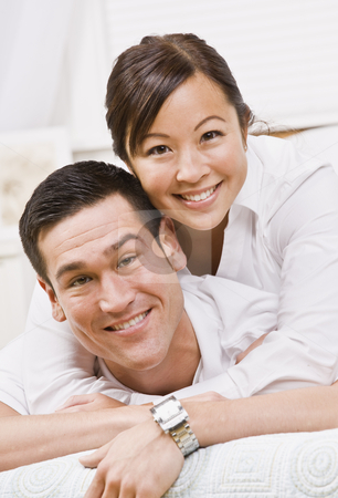 To use this stock image in your creative project, please select the size you need over to the right and click the "Add to Cart" button.
Your downloaded image will come with the Cutcaster watermark removed so don’t worry about the watermark you see on this page. Attractive Couple Hugging and Smiling at the Camera stock photo, An attractive young couple posing. They are wearing white and are looking directly at the camera. Vertically framed photo. by Jonathan Ross