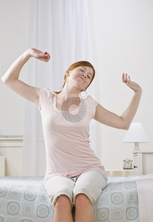 To use this stock image in your creative project, please select the size you need over to the right and click the "Add to Cart" button.
Your downloaded image will come with the Cutcaster watermark removed so don’t worry about the watermark you see on this page. Female Stretching on Her Bed stock photo, A young female stretching her arms. She is sitting on a bed and is smiling. Her eyes are closed. Vertically framed photo. by Jonathan Ross