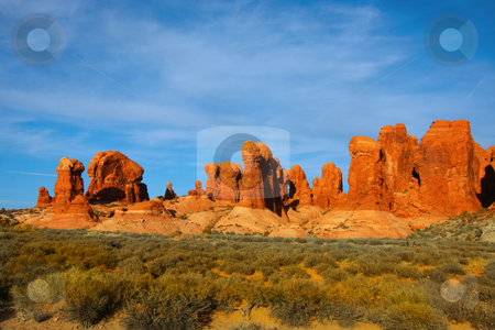 To use this stock image in your creative project, please select the size you need over to the right and click the "Add to Cart" button.
Your downloaded image will come with the Cutcaster watermark removed so don’t worry about the watermark you see on this page. Desert Arches National Park stock photo, View of the red rock formations in Arches National Park with blue sky by Mark Smith