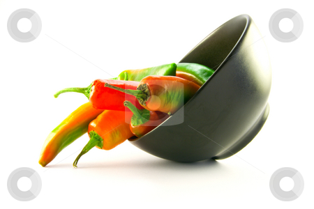 To use this stock image in your creative project, please select the size you need over to the right and click the "Add to Cart" button.
Your downloaded image will come with the Cutcaster watermark removed so don’t worry about the watermark you see on this page. Chillis Spilling out of a Black Bowl stock photo, Mixed red and green chillis spilling out of a black bowl with clipping path on a white background by Keith Wilson