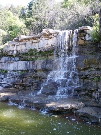 To use this stock image in your creative project, please select the size you need over to the right and click the "Add to Cart" button.
Your downloaded image will come with the Cutcaster watermark removed so don’t worry about the watermark you see on this page. Austin Waterfall stock photo, A waterfall at Zilker Park in Austin, Texas. by Brandon Seidel