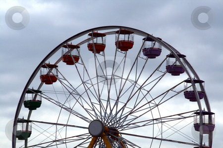 To use this stock image in your creative project, please select the size you need over to the right and click the "Add to Cart" button.
Your downloaded image will come with the Cutcaster watermark removed so don’t worry about the watermark you see on this page. Ferris Wheel against a cloudy sky stock photo, A ferris wheel against a cloudy sky by Brandon Seidel