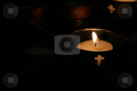 To use this stock image in your creative project, please select the size you need over to the right and click the "Add to Cart" button.
Your downloaded image will come with the Cutcaster watermark removed so don’t worry about the watermark you see on this page. Candles burning in religious cups stock photo, Small votive candles burning in religious cups with cross cutouts by Brandon Seidel