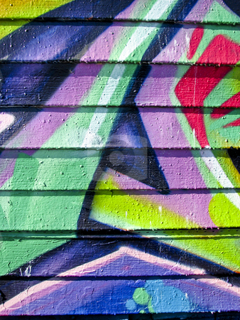 To use this stock image in your creative project, please select the size you need over to the right and click the "Add to Cart" button.
Your downloaded image will come with the Cutcaster watermark removed so don’t worry about the watermark you see on this page. Vibrant graffiti on wood slatted wall stock photo, Purple, pink and green graffiti on an abandoned wood wall by Annette Davis