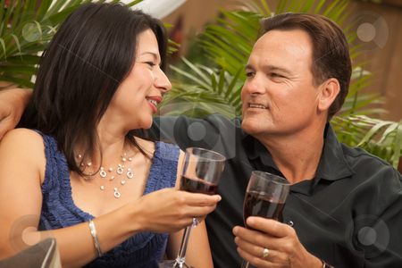To use this stock image in your creative project, please select the size you need over to the right and click the "Add to Cart" button.
Your downloaded image will come with the Cutcaster watermark removed so don’t worry about the watermark you see on this page. Attractive Hispanic and Caucasian Couple Drinking Wine stock photo, Attractive Hispanic and Caucasian Couple Drinking Wine Outside. by Andy Dean
