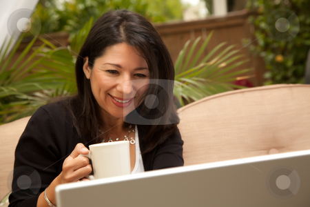 To use this stock image in your creative project, please select the size you need over to the right and click the "Add to Cart" button.
Your downloaded image will come with the Cutcaster watermark removed so don’t worry about the watermark you see on this page. Hispanic Woman with Coffee and Laptop stock photo, Hispanic Woman with Coffee and Laptop On Her Patio. by Andy Dean