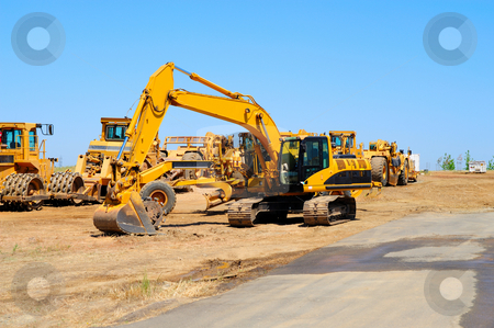 To use this stock image in your creative project, please select the size you need over to the right and click the "Add to Cart" button.
Your downloaded image will come with the Cutcaster watermark removed so don’t worry about the watermark you see on this page. Excavator And Heavy Equipment stock photo, Heavy construction equipment sits idle lined up along a new asphalt road by Lynn Bendickson